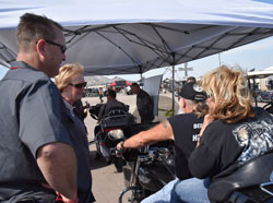 RFA board members Chuck Woodside and Dana Lewis chat with bikers getting free 10% ethanol fuel